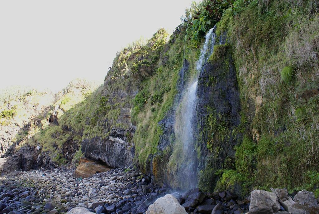 Waterfall on a volcanic coastal cliff on Terceira Island, Azores